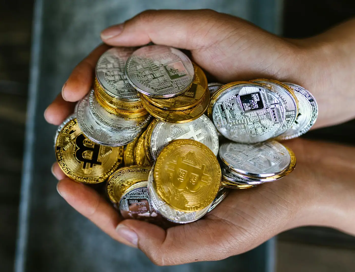 Cryptocurrency coins in hands.